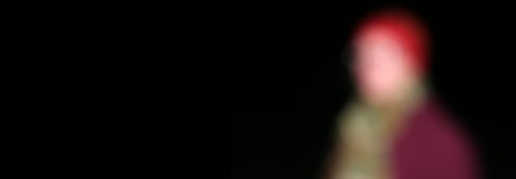 Image of light bulb on black background with simulated halos caused by cataract.